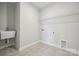 Well-lit laundry room featuring a utility sink, tile flooring, and convenient hookups at 1439 Hubert Graham Way, Tega Cay, SC 29708