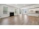 Spacious living area featuring a fireplace, hardwood floors, and a modern, open layout at 1439 Hubert Graham Way, Tega Cay, SC 29708