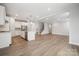 Open floor plan boasts wood floors, recessed lighting, and a view of the staircase at 1439 Hubert Graham Way, Tega Cay, SC 29708