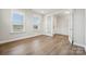 Well-lit office space, featuring hardwood floors and a glass door for privacy and focus at 1439 Hubert Graham Way, Tega Cay, SC 29708