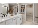 Modern bathroom with double sinks, white cabinetry, and a walk-in closet at 15212 Caspian Way, Charlotte, NC 28278