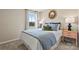 Inviting bedroom with a plush bed, coordinated pillows, side tables, and a sunlit window with scenic views at 15212 Caspian Way, Charlotte, NC 28278