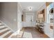 Inviting foyer with staircase, natural light, and stylish decor creating a warm entry to the home at 15212 Caspian Way, Charlotte, NC 28278