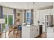 Bright kitchen with island, stainless appliances and eat in dining area with natural light at 15212 Caspian Way, Charlotte, NC 28278