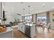Modern kitchen with a large island, stainless steel appliances, and a seamless view into the living room at 15212 Caspian Way, Charlotte, NC 28278