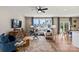Bright living room featuring hardwood floors, a ceiling fan, and abundant natural light at 15212 Caspian Way, Charlotte, NC 28278