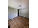 Cozy bedroom featuring light gray walls, wood-look floors, and bright natural light at 1608 Van Dyke Dr, Charlotte, NC 28213