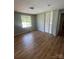 Bright bedroom featuring a window, wood-look floors, and a double door closet at 1608 Van Dyke Dr, Charlotte, NC 28213