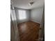 Bedroom featuring gray walls, wood-look floors, and natural light from window at 1608 Van Dyke Dr, Charlotte, NC 28213
