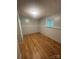 Bedroom showcasing wood-look floors, a single window, and wainscoting at 1608 Van Dyke Dr, Charlotte, NC 28213