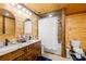 Bathroom with double sink vanity, wood paneling, and shower-tub combo at 164 Linderman Lake Ln, Kings Mountain, NC 28086