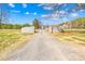Stone entrance with beautiful blooming trees and landscaping at 164 Linderman Lake Ln, Kings Mountain, NC 28086