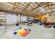 Open garage with multiple garage door openers and storage at 164 Linderman Lake Ln, Kings Mountain, NC 28086