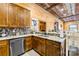 Modern kitchen featuring stainless steel dishwasher, granite countertops and wood cabinetry at 164 Linderman Lake Ln, Kings Mountain, NC 28086