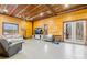 Open-concept living room with wood walls, concrete floors, comfortable seating, and natural light at 164 Linderman Lake Ln, Kings Mountain, NC 28086
