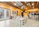 Rustic living room with wood walls, dining table, hutch, and door to the outdoors at 164 Linderman Lake Ln, Kings Mountain, NC 28086