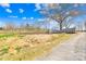 Gated entrance to the property with a wooden fence and tree; perfect for rural living at 164 Linderman Lake Ln, Kings Mountain, NC 28086