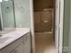 Neutral bathroom with a vanity and shower-tub featuring sleek sliding glass doors and neutral decor at 19915 Oak Leaf Cir, Cornelius, NC 28031
