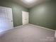Spacious carpeted bedroom with closet and ample natural light from the window, providing an open feel at 19915 Oak Leaf Cir, Cornelius, NC 28031