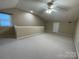 Spacious bonus room featuring neutral paint, carpeting, a ceiling fan, and natural light at 19915 Oak Leaf Cir, Cornelius, NC 28031