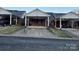 Street view of homes featuring carports, brick facade, and tidy yards at 19915 Oak Leaf Cir, Cornelius, NC 28031