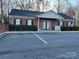 Charming brick commercial building with a well-maintained facade, black shutters, and accessible parking at 19915 Oak Leaf Cir, Cornelius, NC 28031