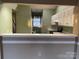 Kitchen pass through shows countertops and white cabinets at 19915 Oak Leaf Cir, Cornelius, NC 28031