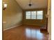 Inviting living room with a ceiling fan, natural light from a large window, and brick fireplace at 19915 Oak Leaf Cir, Cornelius, NC 28031
