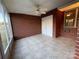 Brick enclosed sunroom featuring tile floors, ceiling fan, windows, and a neutral color walls at 19915 Oak Leaf Cir, Cornelius, NC 28031