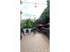 Spacious back deck with lounge chairs, potted plants, string lights, and an adjacent hot tub with privacy screening at 205 Edenshire Ct, Indian Trail, NC 28079