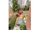 Elevated view of backyard with hot tub, deck, lounge chairs, dining area, and lush greenery creating a private retreat at 205 Edenshire Ct, Indian Trail, NC 28079