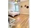 Bright bedroom featuring hardwood floors, a ceiling fan, and a large window for ample natural light at 205 Edenshire Ct, Indian Trail, NC 28079