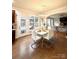 Light-filled dining area features wood floors, modern chandelier, and an open flow to the connected living spaces at 205 Edenshire Ct, Indian Trail, NC 28079
