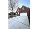 Spacious two-story brick home with an attached two-car garage and a wide driveway for extra parking at 205 Edenshire Ct, Indian Trail, NC 28079