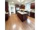 Modern kitchen with dark wood cabinetry, stainless steel appliances, granite countertops, and a center island at 205 Edenshire Ct, Indian Trail, NC 28079