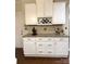 Kitchen with white cabinets, granite countertops, and a built-in wine rack above the countertop at 205 Edenshire Ct, Indian Trail, NC 28079