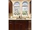 Close-up of a kitchen sink area with granite countertops, stylish faucet, and double windows at 205 Edenshire Ct, Indian Trail, NC 28079