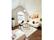 Bright living room with vaulted ceilings, a large window, and a white sectional sofa with red pillows at 205 Edenshire Ct, Indian Trail, NC 28079