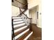 Elegant staircase with hardwood steps, wrought iron railings, and a wood banister at 205 Edenshire Ct, Indian Trail, NC 28079