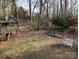 A view of the backyard, complete with a playhouse, swing set and garden at 215 Biscoe Rd, Troy, NC 27371