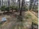 Fenced backyard with outdoor seating and mature trees offering a serene setting at 215 Biscoe Rd, Troy, NC 27371