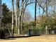 Fenced backyard with mature trees and an inviting outdoor space, offering privacy and a serene setting at 215 Biscoe Rd, Troy, NC 27371