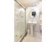 Bathroom featuring a walk-in shower with glass door and pedestal sink at 215 Biscoe Rd, Troy, NC 27371