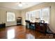 Bright bonus room with hardwood floors, natural light, and versatile storage solutions at 215 Biscoe Rd, Troy, NC 27371