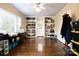 Versatile bonus room with built-in shelving, hardwood floors, and neutral decor at 215 Biscoe Rd, Troy, NC 27371