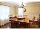 Classic dining room with wooden table, chairs, chandelier, and decorative wall accents at 215 Biscoe Rd, Troy, NC 27371
