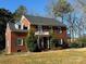 Charming two-story brick home with manicured front yard and dormer windows at 215 Biscoe Rd, Troy, NC 27371