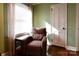 Cozy reading nook with patterned armchair, window, and hardwood floors at 215 Biscoe Rd, Troy, NC 27371