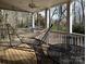 Inviting covered porch with a hammock, table and chairs, perfect for outdoor relaxation at 215 Biscoe Rd, Troy, NC 27371