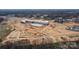 Aerial view highlights a home's proximity to a large construction site at 244 Stilwell Oaks Cir, Charlotte, NC 28212